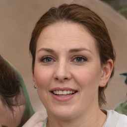 Joyful white adult female with medium  brown hair and brown eyes