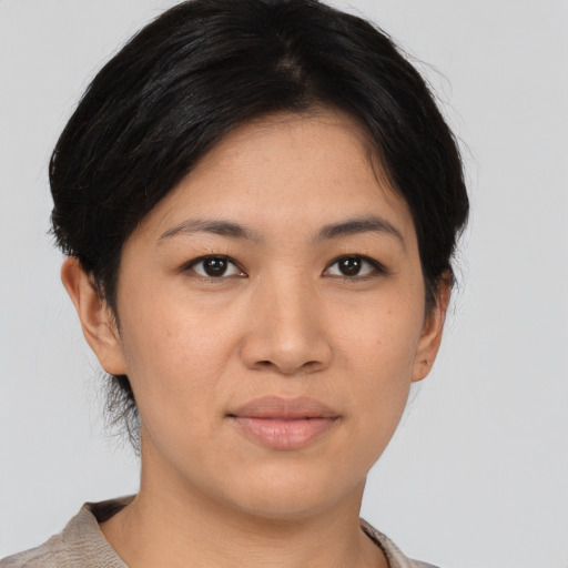 Joyful asian young-adult female with short  brown hair and brown eyes