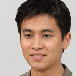 Joyful asian young-adult male with short  brown hair and brown eyes