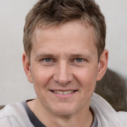 Joyful white adult male with short  brown hair and grey eyes