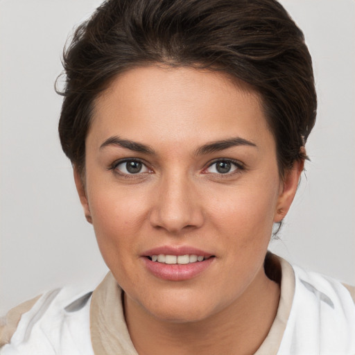 Joyful white young-adult female with short  brown hair and brown eyes