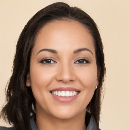 Joyful white young-adult female with long  brown hair and brown eyes