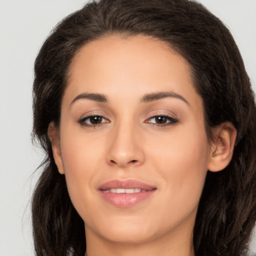 Joyful white young-adult female with long  brown hair and brown eyes