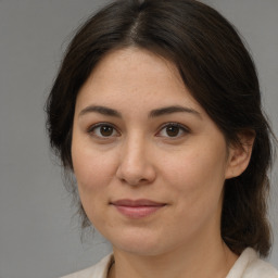 Joyful white adult female with medium  brown hair and brown eyes