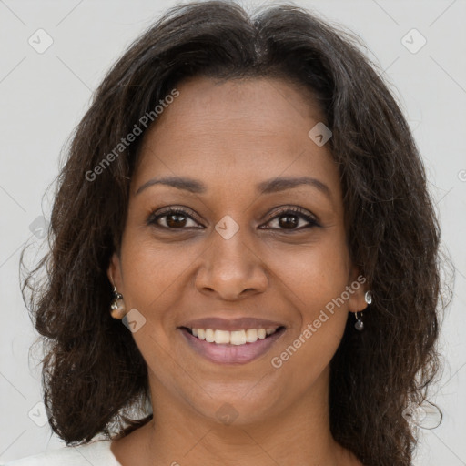 Joyful black young-adult female with long  brown hair and brown eyes