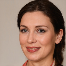 Joyful white adult female with medium  brown hair and brown eyes