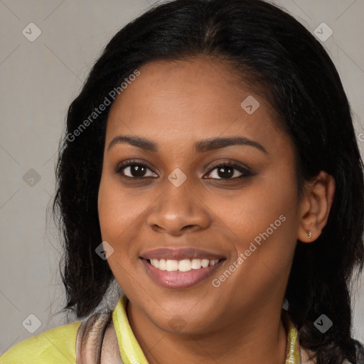 Joyful black young-adult female with long  brown hair and brown eyes