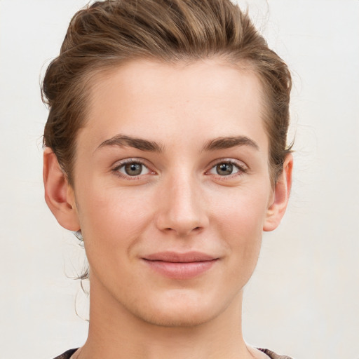 Joyful white young-adult female with short  brown hair and grey eyes