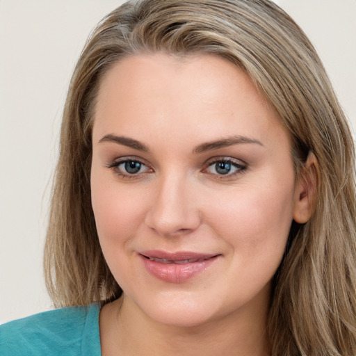 Joyful white young-adult female with long  brown hair and blue eyes