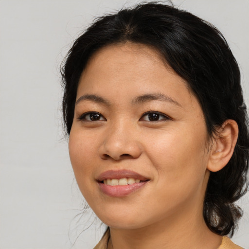 Joyful asian young-adult female with medium  brown hair and brown eyes