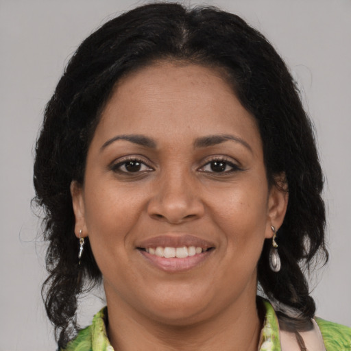 Joyful black adult female with medium  brown hair and brown eyes