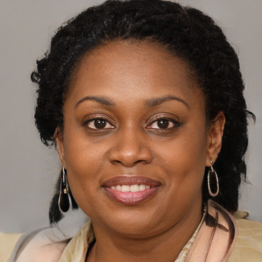 Joyful black young-adult female with medium  brown hair and brown eyes