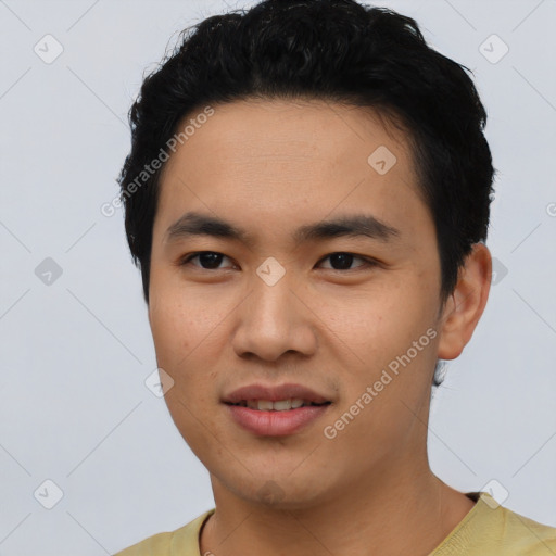 Joyful asian young-adult male with short  black hair and brown eyes