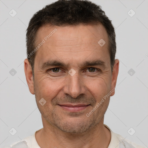 Joyful white adult male with short  brown hair and brown eyes