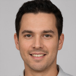 Joyful white young-adult male with short  brown hair and brown eyes