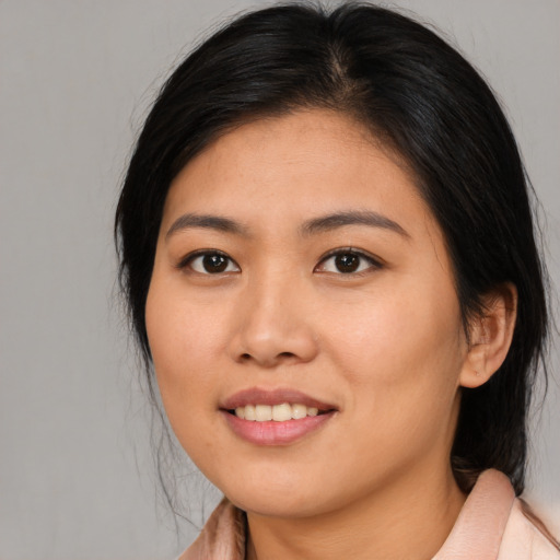 Joyful asian young-adult female with medium  black hair and brown eyes