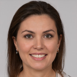 Joyful white young-adult female with long  brown hair and grey eyes