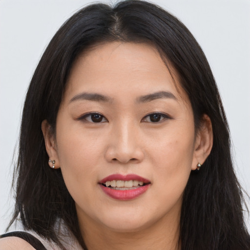 Joyful asian young-adult female with long  brown hair and brown eyes
