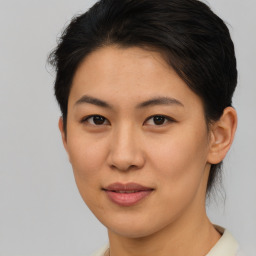 Joyful asian young-adult female with short  brown hair and brown eyes