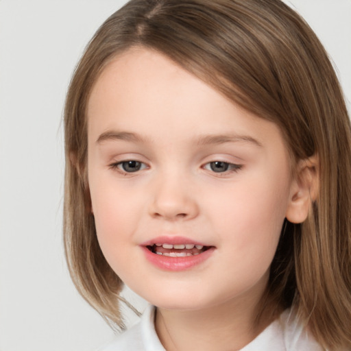 Joyful white child female with medium  brown hair and brown eyes