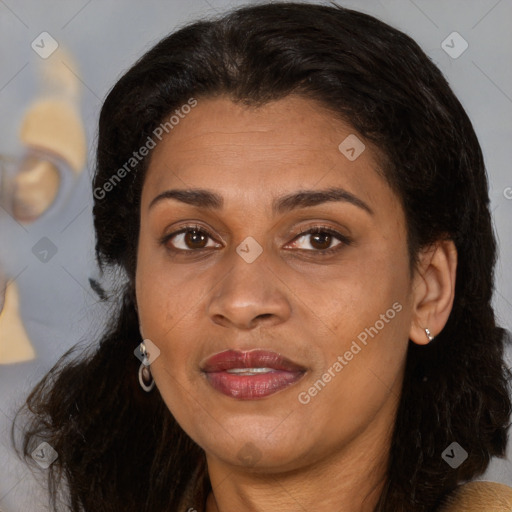 Joyful latino adult female with medium  brown hair and brown eyes