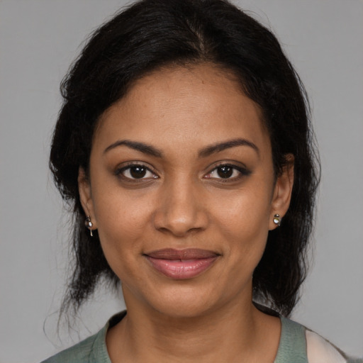 Joyful black young-adult female with medium  brown hair and brown eyes