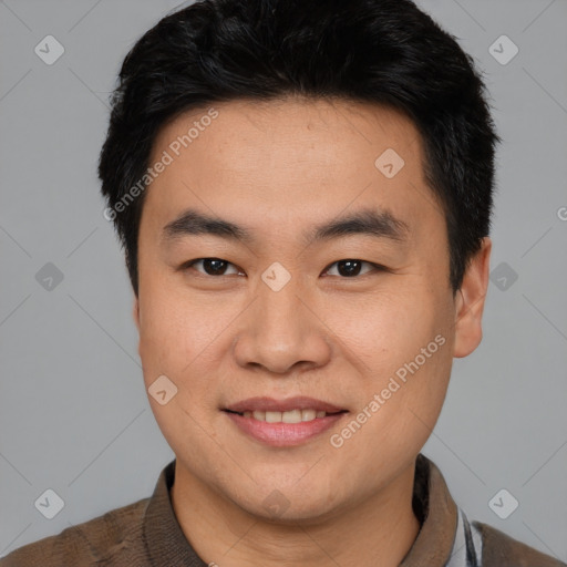 Joyful asian young-adult male with short  brown hair and brown eyes