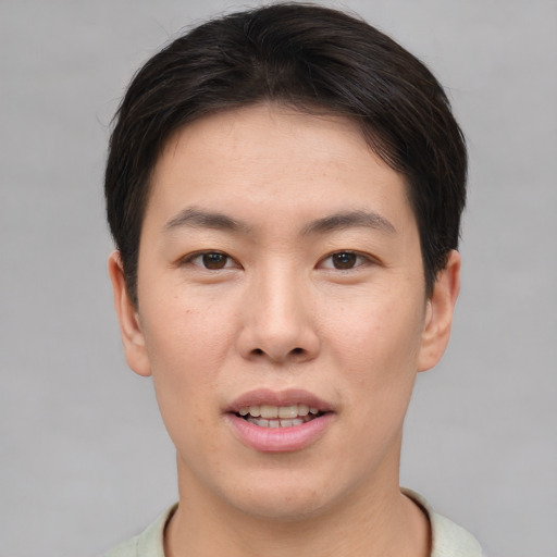 Joyful asian young-adult male with short  brown hair and brown eyes