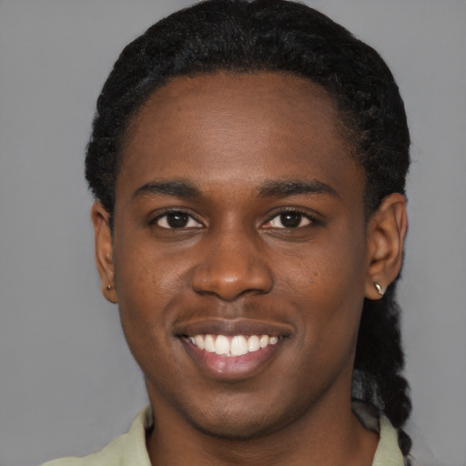 Joyful black young-adult male with short  brown hair and brown eyes