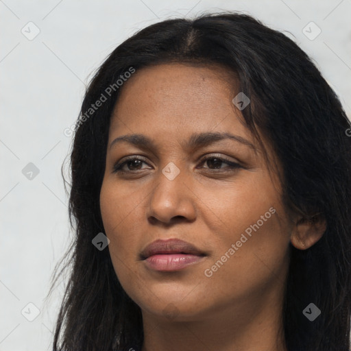 Joyful black young-adult female with long  black hair and brown eyes