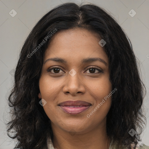 Joyful black young-adult female with long  brown hair and brown eyes