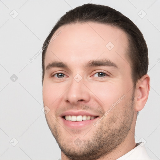 Joyful white young-adult male with short  brown hair and brown eyes