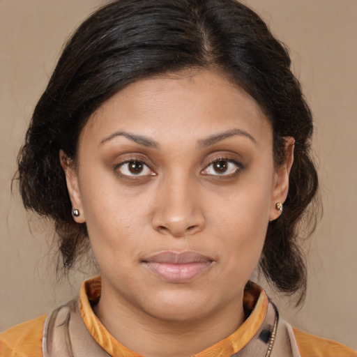 Joyful latino young-adult female with medium  brown hair and brown eyes