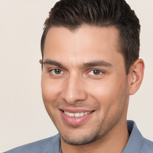 Joyful white young-adult male with short  brown hair and brown eyes