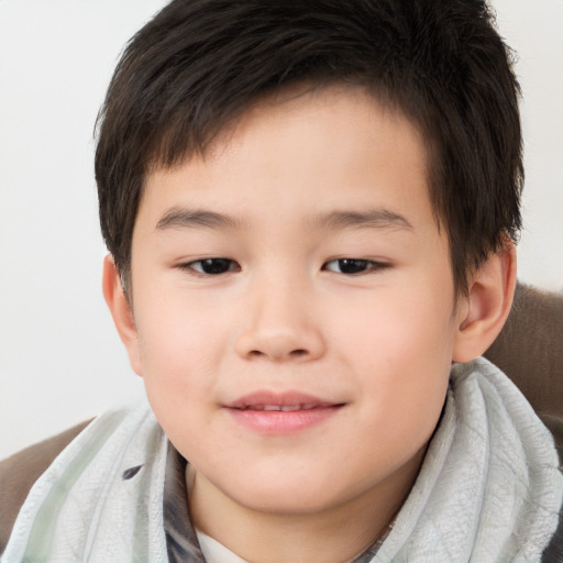 Joyful white child male with short  brown hair and brown eyes