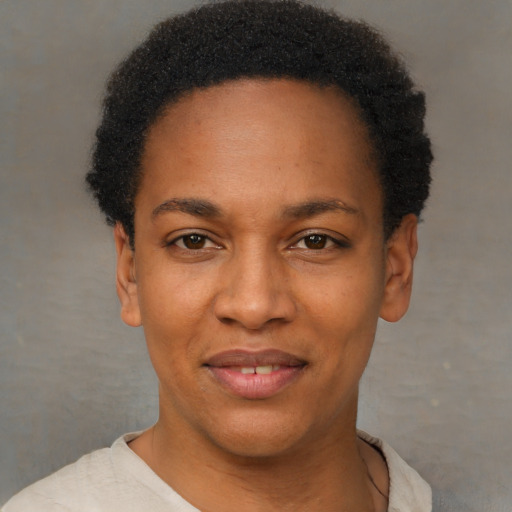 Joyful black young-adult female with short  black hair and brown eyes