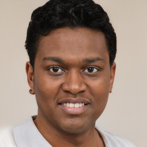 Joyful black young-adult male with short  black hair and brown eyes