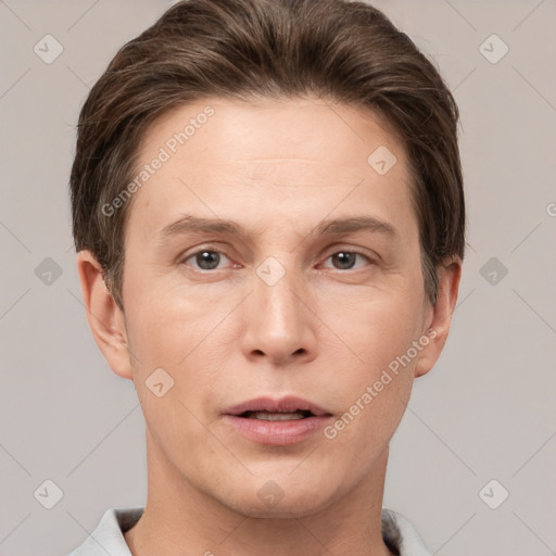 Joyful white adult male with short  brown hair and grey eyes