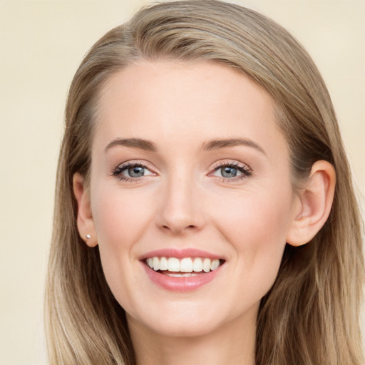 Joyful white young-adult female with long  brown hair and blue eyes