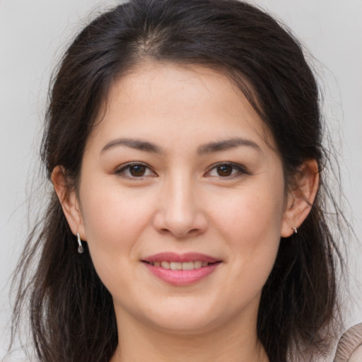 Joyful white young-adult female with long  brown hair and brown eyes