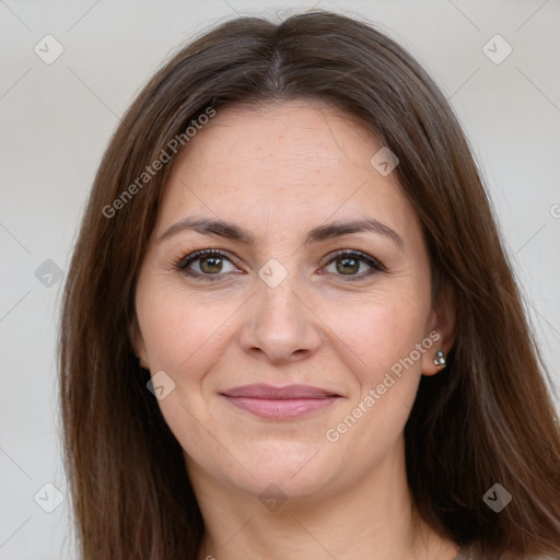 Joyful white adult female with long  brown hair and brown eyes