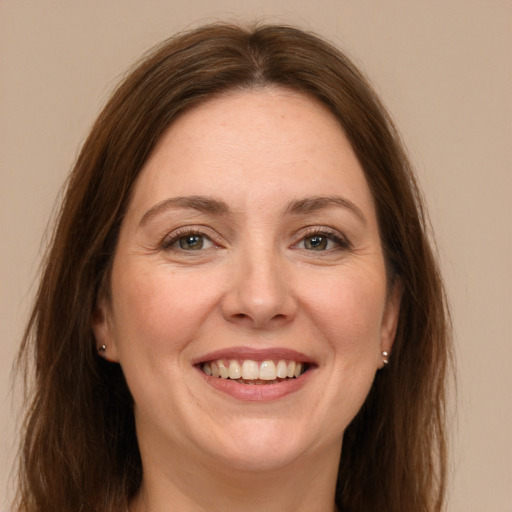 Joyful white young-adult female with long  brown hair and grey eyes