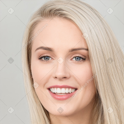 Joyful white young-adult female with long  brown hair and blue eyes