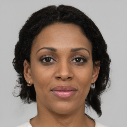 Joyful black young-adult female with medium  brown hair and brown eyes