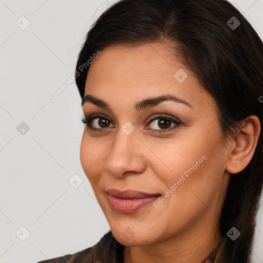 Joyful latino young-adult female with long  brown hair and brown eyes