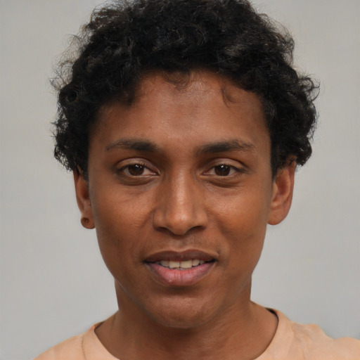 Joyful black young-adult male with short  black hair and brown eyes