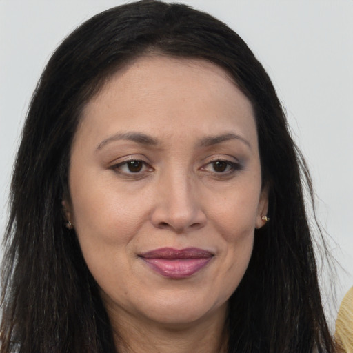 Joyful white adult female with long  brown hair and brown eyes