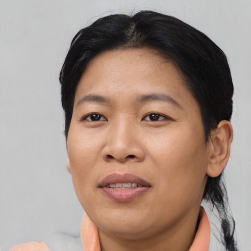 Joyful asian adult female with short  black hair and brown eyes