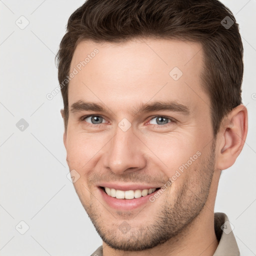 Joyful white young-adult male with short  brown hair and brown eyes