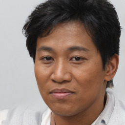 Joyful asian adult male with short  brown hair and brown eyes